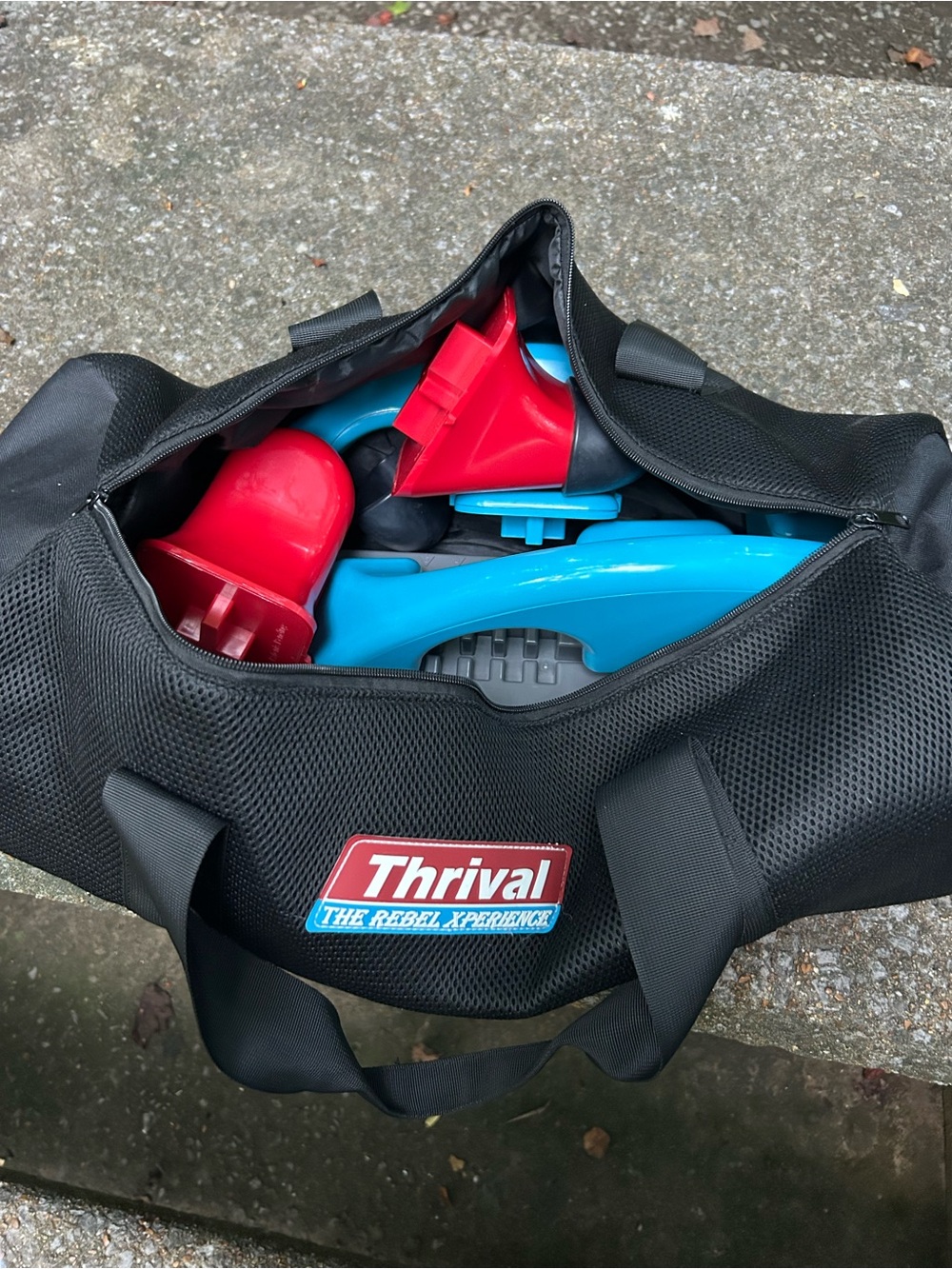 Thrival Black Duffel Bag with Blue and Red Accessories